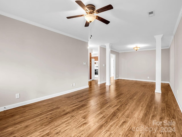 unfurnished living room featuring ceiling fan, hardwood / wood-style flooring, ornate columns, and crown molding