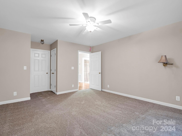 interior space featuring carpet and ceiling fan