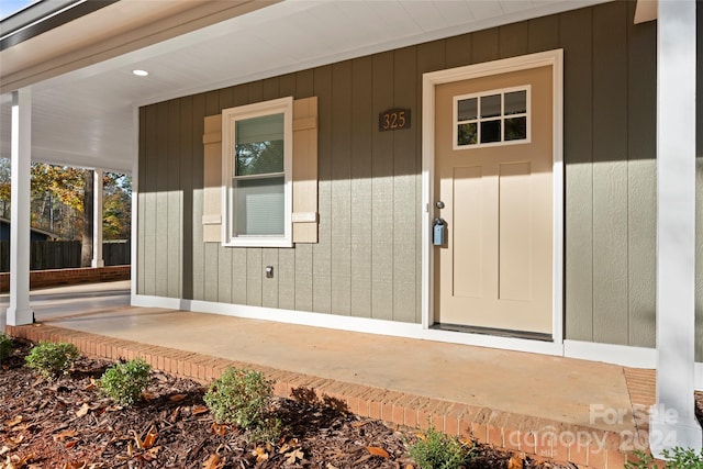 view of exterior entry with covered porch