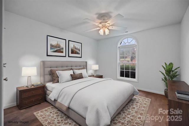 bedroom featuring ceiling fan and dark wood-type flooring