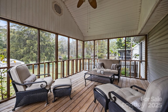 sunroom / solarium featuring lofted ceiling and ceiling fan