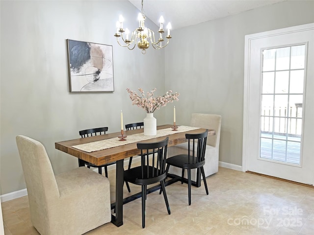 dining room featuring vaulted ceiling, a chandelier, and plenty of natural light