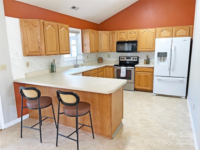 kitchen with sink, stainless steel electric range oven, white fridge with ice dispenser, and backsplash