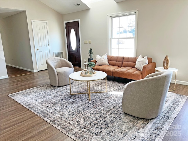 living room with lofted ceiling and dark wood-type flooring