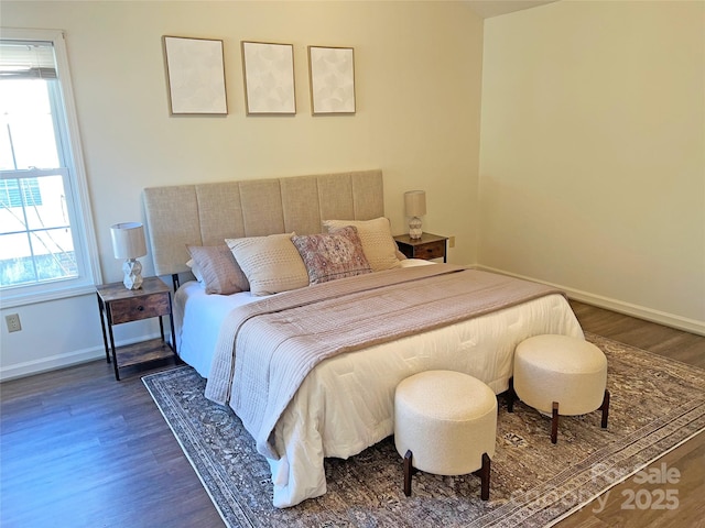 bedroom featuring dark hardwood / wood-style flooring and multiple windows