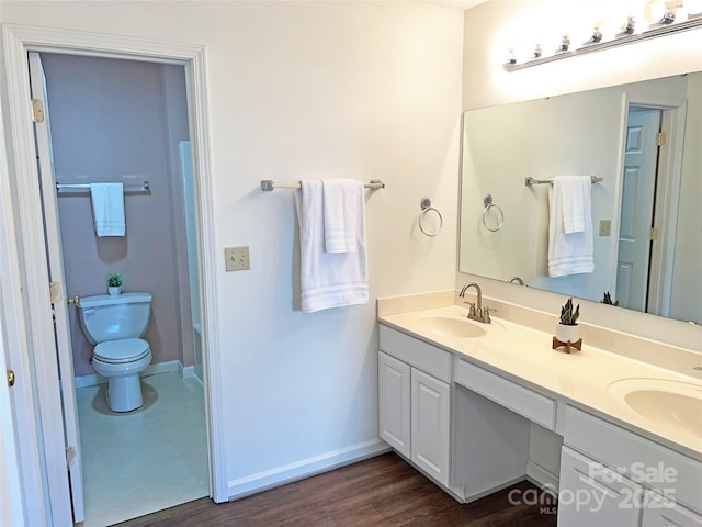 bathroom featuring hardwood / wood-style flooring, vanity, and toilet