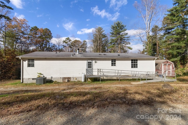 rear view of property featuring central AC