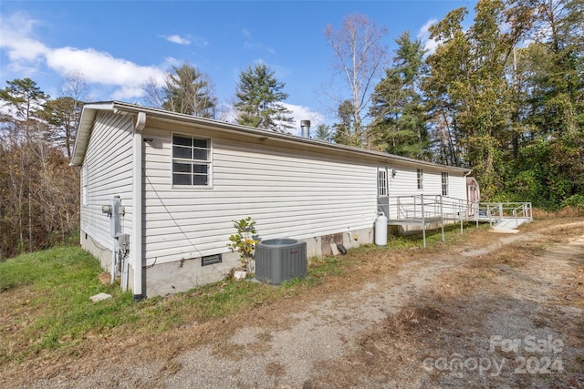 view of side of home featuring cooling unit