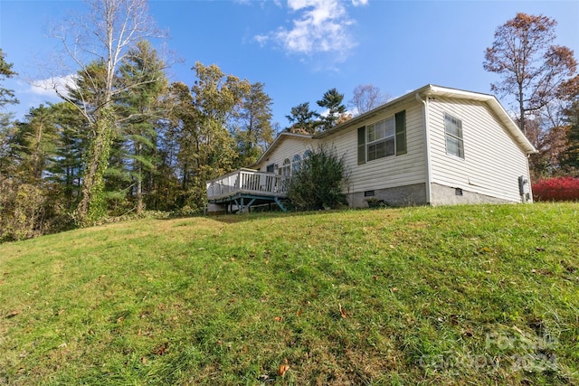 exterior space featuring a lawn and a deck