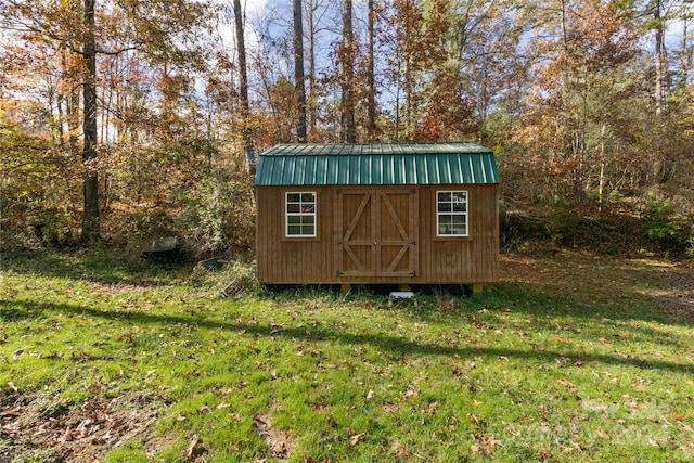 view of outdoor structure with a lawn