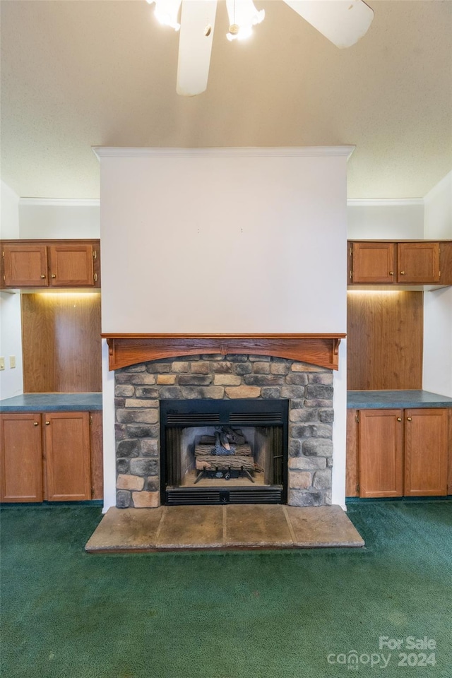 room details with a stone fireplace, crown molding, and carpet floors