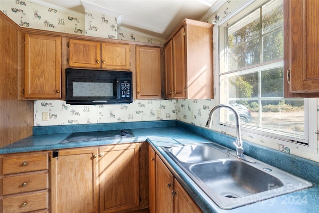 kitchen with lofted ceiling, crown molding, sink, and white stovetop