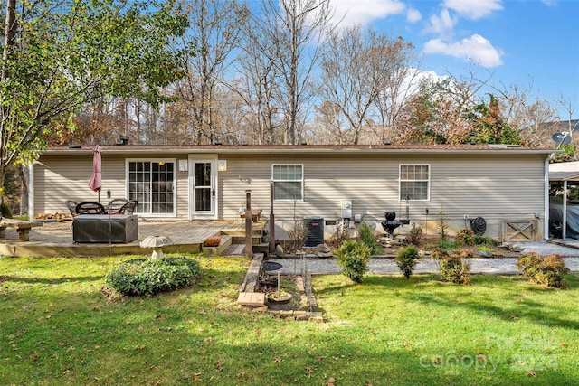 back of house with a yard and a deck