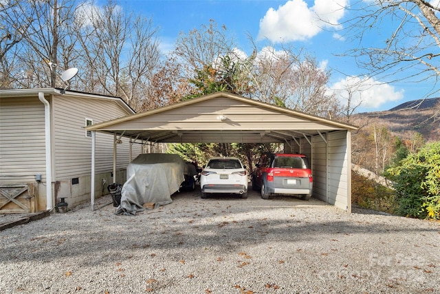 view of parking featuring a mountain view and a carport