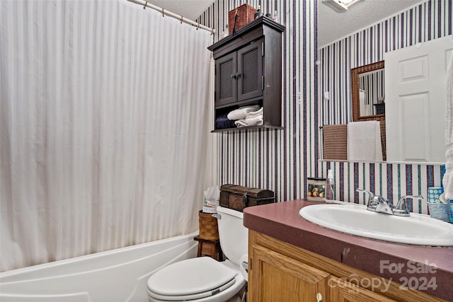 full bathroom with toilet, vanity, a textured ceiling, and shower / bath combo with shower curtain