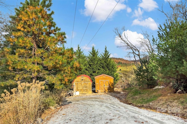 view of gate with a shed