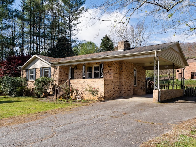 ranch-style home featuring a front yard and a carport