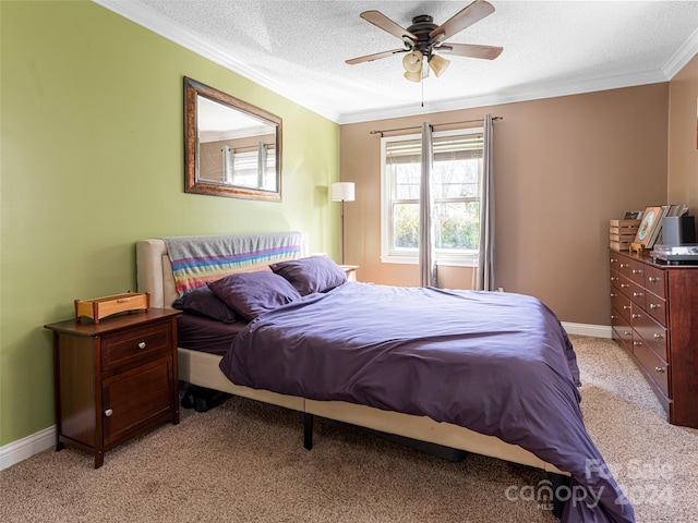 carpeted bedroom featuring a textured ceiling, ceiling fan, and crown molding