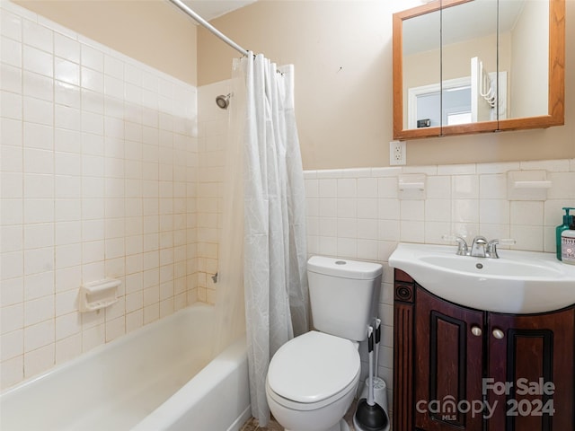 full bathroom with vanity, toilet, tile walls, and shower / bathtub combination with curtain