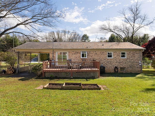 rear view of property featuring a yard and a wooden deck