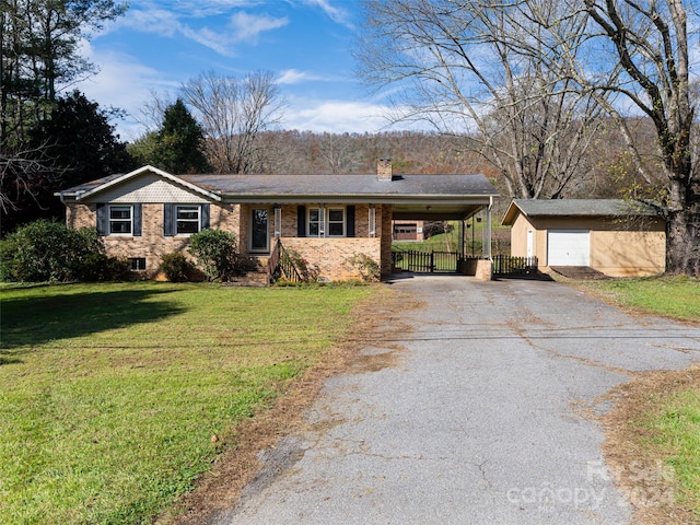 ranch-style home featuring a garage, a front lawn, an outbuilding, and a carport