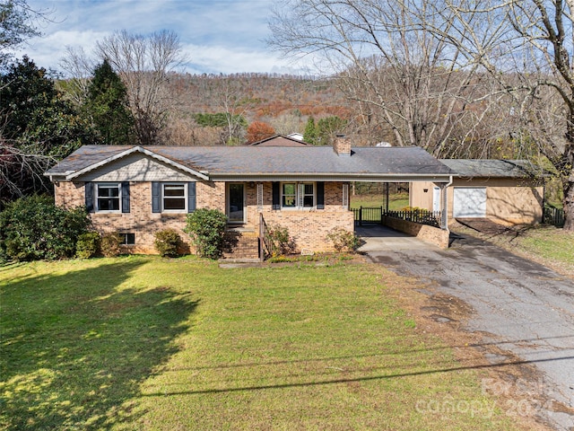 ranch-style house with a front lawn, a garage, and a carport