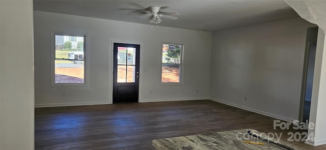 entrance foyer with ceiling fan and dark wood-type flooring