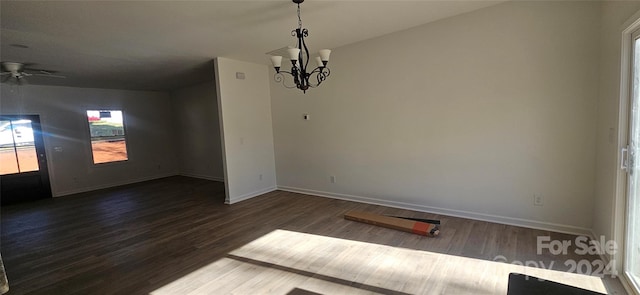 spare room featuring ceiling fan with notable chandelier and dark hardwood / wood-style floors