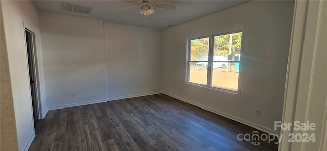 empty room with ceiling fan and dark hardwood / wood-style floors