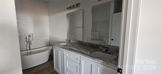 bathroom with vanity, hardwood / wood-style flooring, and a bathing tub