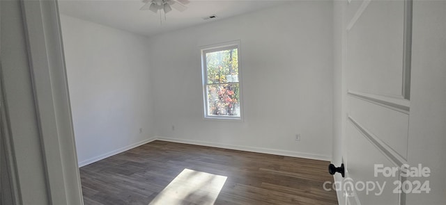 empty room featuring ceiling fan and dark wood-type flooring