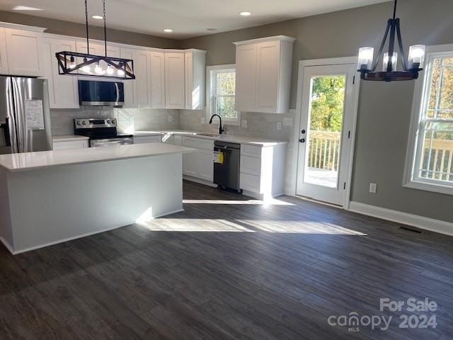 kitchen with white cabinets, a wealth of natural light, stainless steel appliances, and dark wood-type flooring