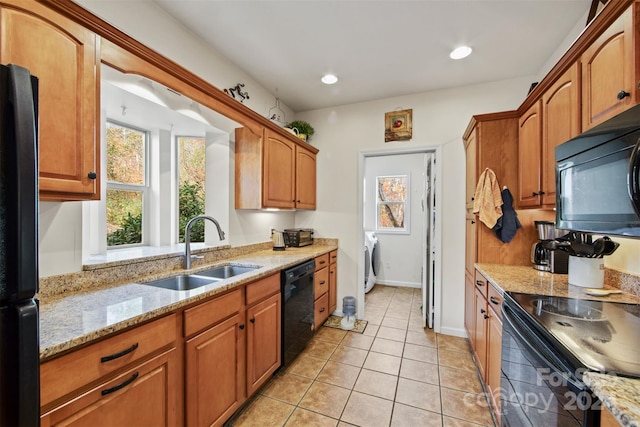 688 Olympic Dr Unit 2, Whittier, NC 28789 - kitchen featuring black appliances, a sink, light tile patterned floors, light stone counters, and washer / clothes dryer