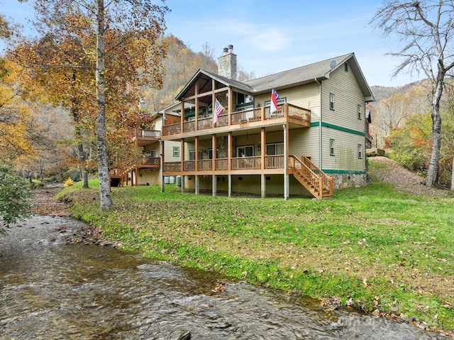 688 Olympic Dr Unit 2, Whittier, NC 28789 - rear view of property featuring a wooden deck, stairway, a chimney, and a lawn