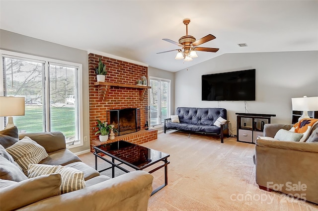 living room featuring ceiling fan, a brick fireplace, vaulted ceiling, and plenty of natural light