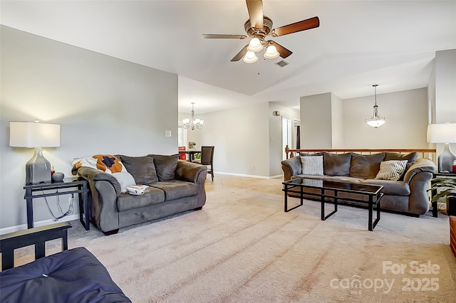 living room featuring ceiling fan with notable chandelier, light colored carpet, and vaulted ceiling