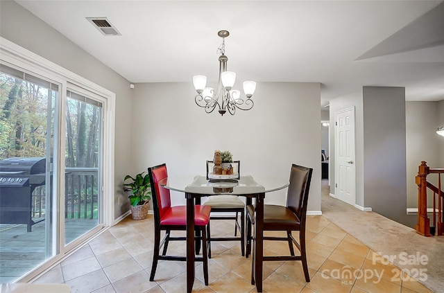 tiled dining room with a chandelier