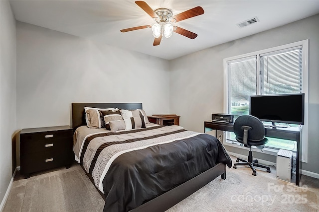 bedroom featuring ceiling fan and light carpet