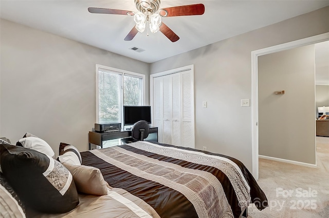 carpeted bedroom with a closet and ceiling fan