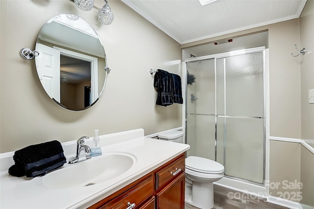 bathroom with a shower with door, vanity, and toilet