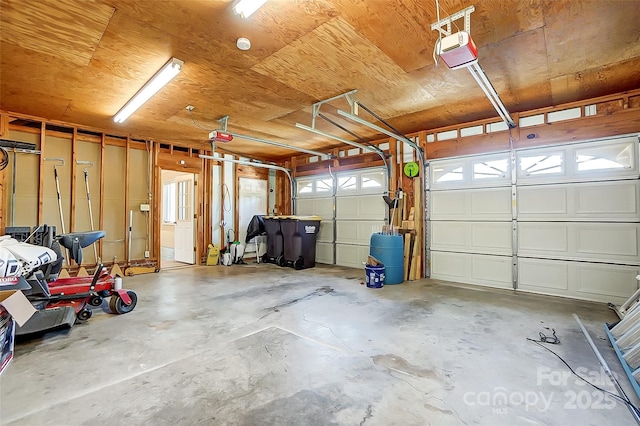 garage with a garage door opener and wood ceiling