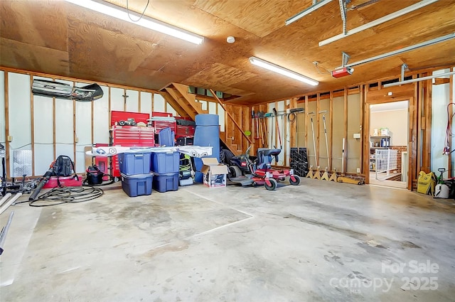 garage with a garage door opener and wooden ceiling