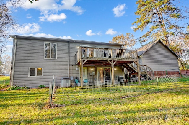 rear view of house featuring cooling unit, a deck, and a yard