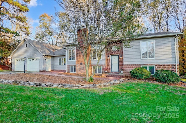 bi-level home with a front yard and a garage