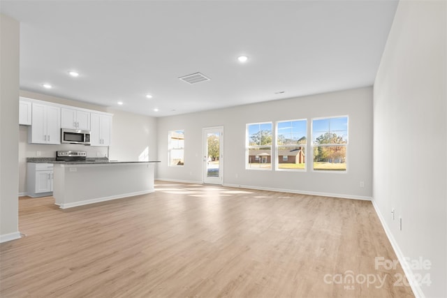 unfurnished living room with light wood-type flooring