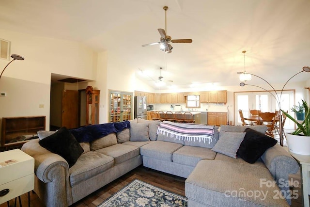 living room with ceiling fan, dark hardwood / wood-style flooring, and high vaulted ceiling