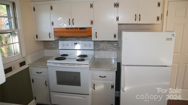 kitchen with white cabinets, white appliances, exhaust hood, and tasteful backsplash