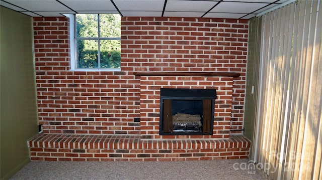 details with a paneled ceiling, a large fireplace, and carpet floors