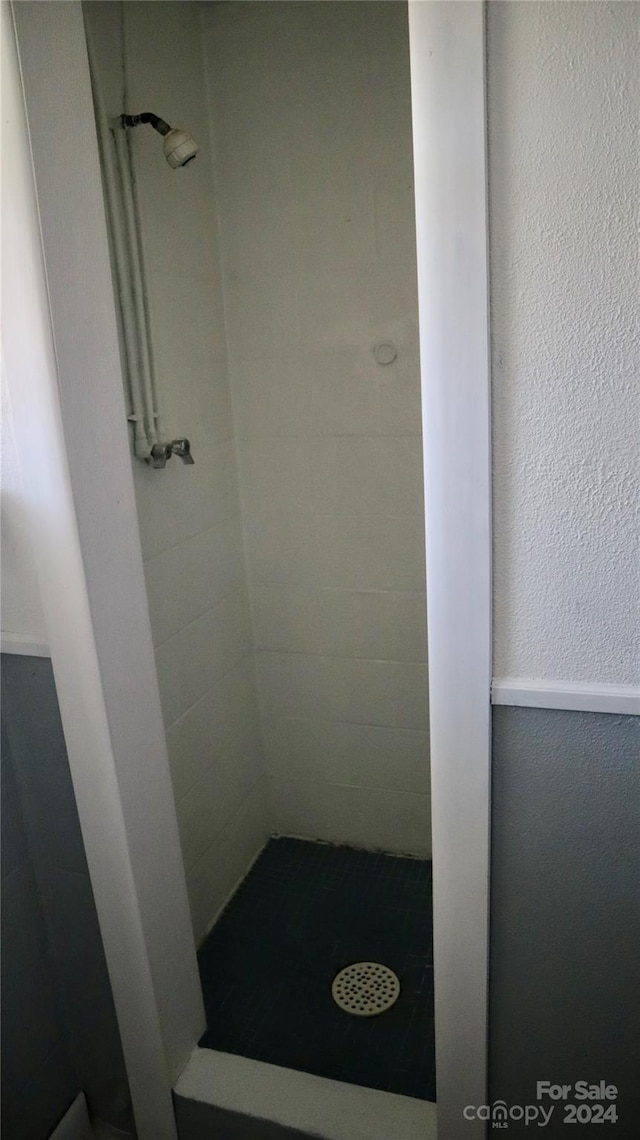 bathroom with a tile shower