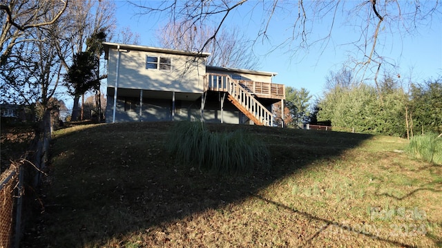 back of house with a lawn and a wooden deck